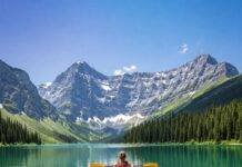 Unforgettable Outdoor Adventures for Nature Lovers Kayaking on crystal lake, snow mountains.