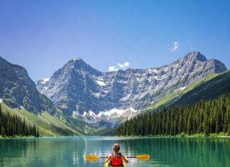 Unforgettable Outdoor Adventures for Nature Lovers Kayaking on crystal lake, snow mountains.