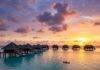 Top 10 Best Beach Resorts for an Unforgettable Getaway in 2025 Luxurious overwater villas at sunset.