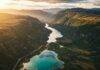 Top 10 Hidden Gems in National Parks You Must Visit in 2025 Aerial view of turquoise lake and mountains.