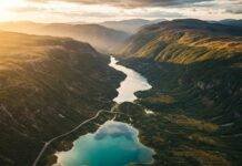 Top 10 Hidden Gems in National Parks You Must Visit in 2025 Aerial view of turquoise lake and mountains.