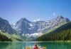 Unforgettable Outdoor Adventures for Nature Lovers Kayaking on crystal lake, snow mountains.