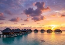 Top 10 Best Beach Resorts for an Unforgettable Getaway in 2025 Luxurious overwater villas at sunset.