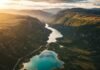Top 10 Hidden Gems in National Parks You Must Visit in 2025 Aerial view of turquoise lake and mountains.