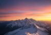 7 Mountain Adventures You Need to Experience Before You Die Sunrise mountain panorama with hiker.