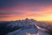 7 Mountain Adventures You Need to Experience Before You Die Sunrise mountain panorama with hiker.