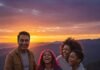 How to Plan the Perfect Family Vacation Without Breaking the Bank A diverse family enjoys a vibrant sunset view, laughing together.