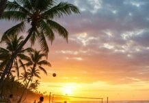 10 Exciting Beach Activities to Add to Your Summer Bucket List Vibrant beach sunset with surfing, volleyball, and paddleboarding.