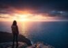 Exploring Solo Activities: The Ultimate Guide for Independent Souls Solo traveler on cliff at sunset over ocean.